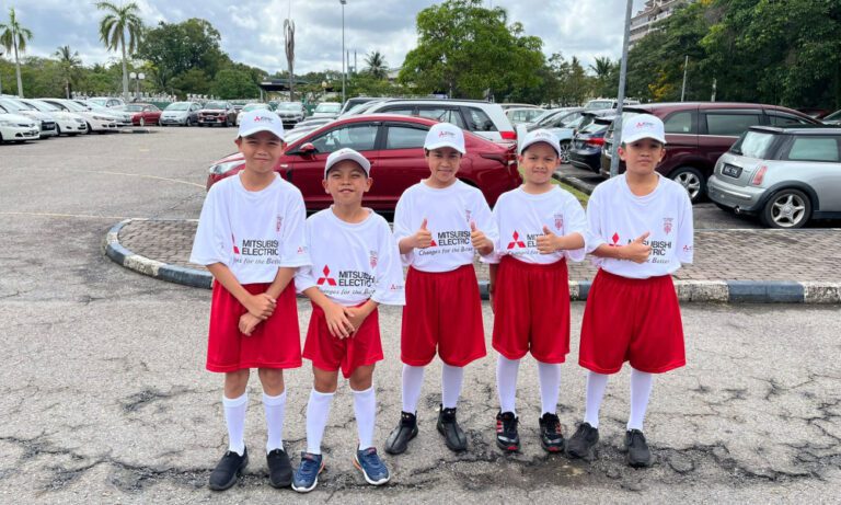 Kids at the AFF Mitsubishi Cup in Thailand wearing Mitsubishi-branded Dri-Fit tees by Imprint Singapore.
