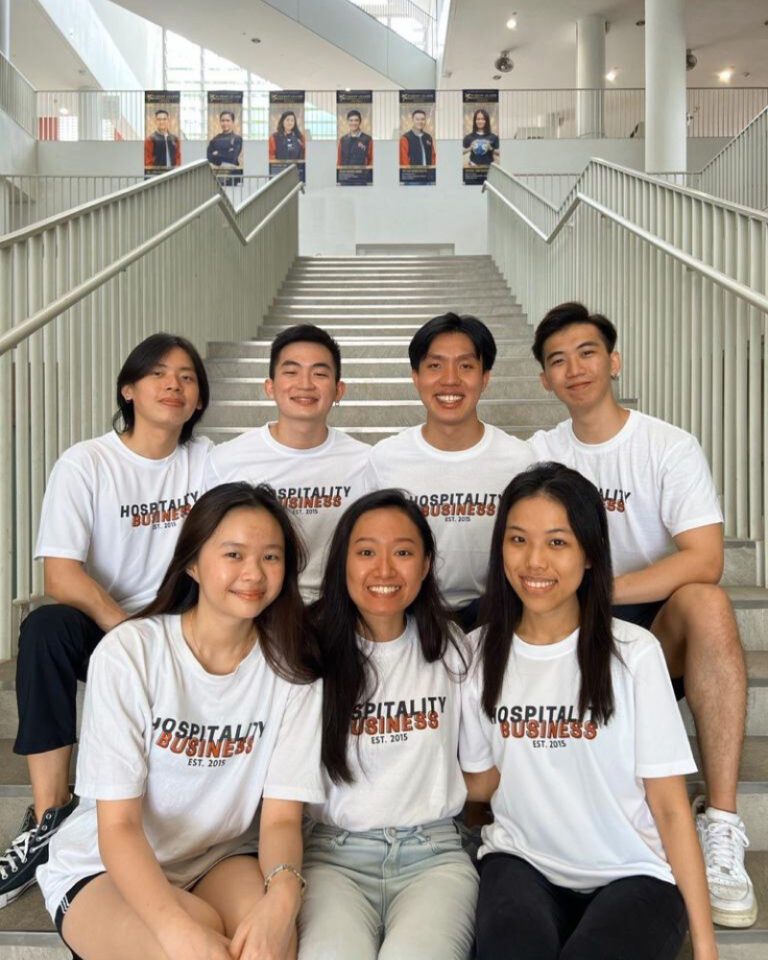 SIT Hospitality Business students in a professional setting, wearing custom attire by Imprint Singapore.
