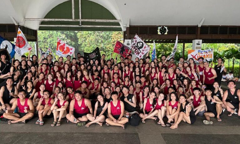 School camp students in an outdoor learning session, sporting Imprint Singapore custom gear.
