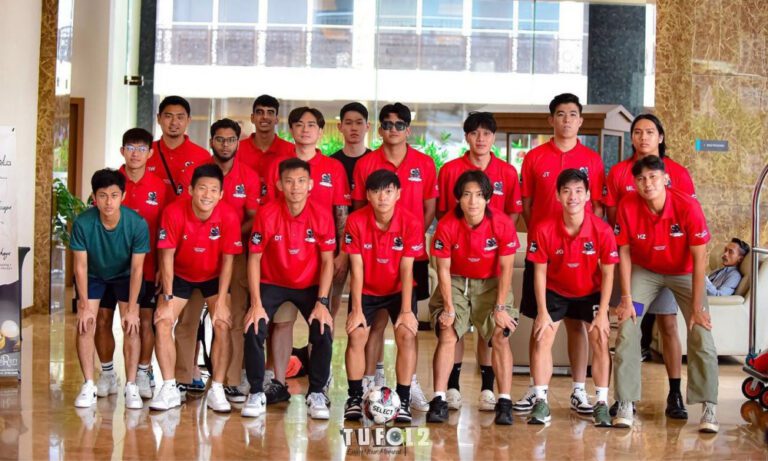 Futsal team in a huddle, wearing custom red Dri-Fit polo tees by Imprint Singapore T-Shirt Printing